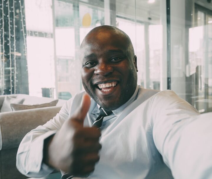 Man in a suit gives a thumbs up